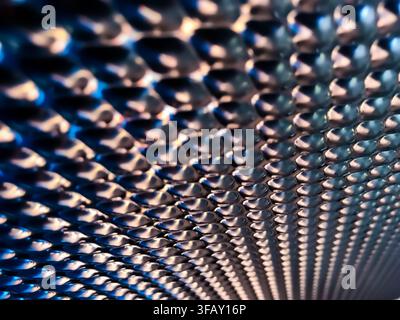 Abstract macro of metallic textured surface with diagonal pattern creating futuristic industrial background. Stock Photo