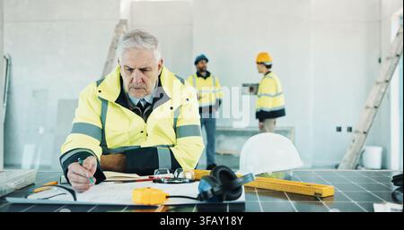 Engineer, drawing and man with blueprint, construction or plan for property development with design. Architecture, sketch and mature person with Stock Photo