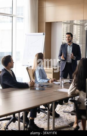 Middle-eastern businessman presenting strategy to team in boardroom Stock Photo