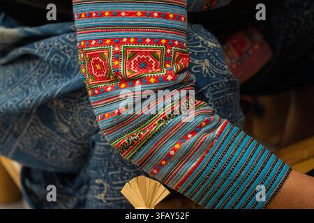 Macro close-up of colorful geometric embroidery on ethnic minority sleeve, Hanoi, Vietnam Stock Photo