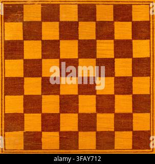Wooden chessboard. An old wooden chessboard close-up. Stock Photo