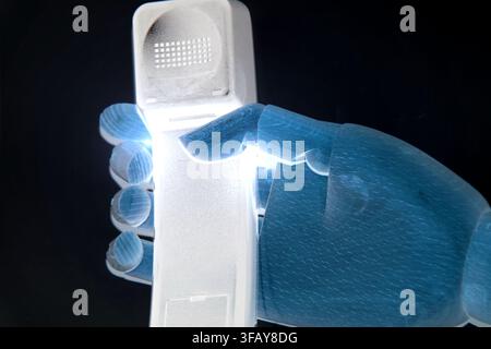 Robotic Hand Holding Wireless Phone for Future Communication Concept Stock Photo