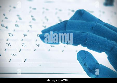 A robotic hand placed on a computer keyboard, symbolizing artificial intelligence, automation, digital interaction, and the connection between humans Stock Photo