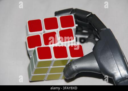 Futuristic Robot Hand Holding Colorful Rubik's Cube, AI Technology and Innovation Concept Stock Photo