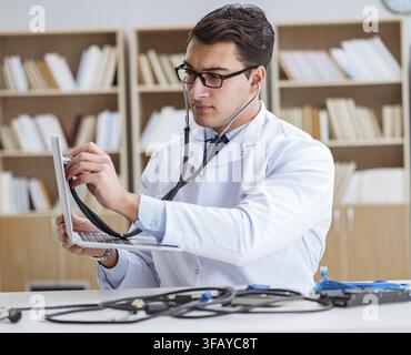 The IT technician repairs a broken laptop notebook Stock Photo