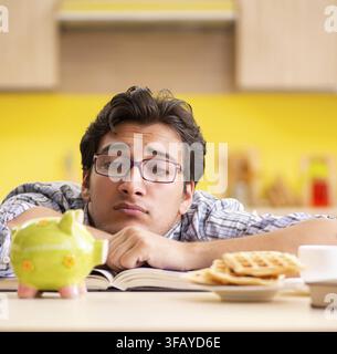 The student is preparing for the exam and is sitting in the kitchen Stock Photo