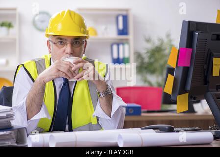 Old male architect working in office Stock Photo
