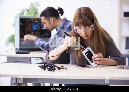 The two technicians who work in the computer warranty center Stock Photo