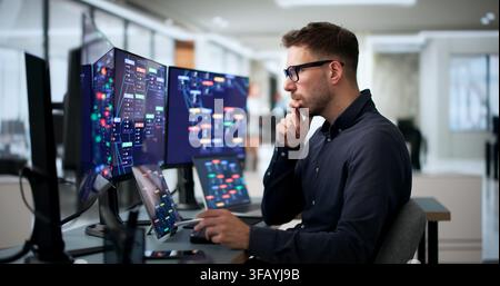 Young Software Developer Uses Laptop And Tablet To Build Workflows Quickly. Stock Photo