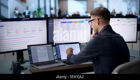 Business Analyst Uses Laptop To Monitor Real-time Dashboard Ensuring Smooth Operations. Stock Photo