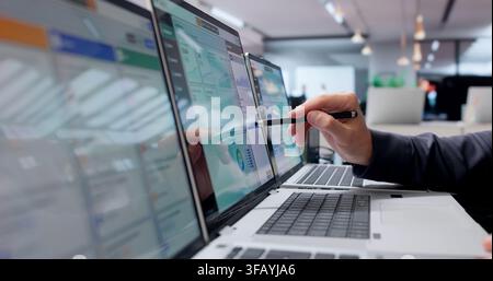Young Man Works On Cloud ERP System Using Laptop For Business Management. Stock Photo