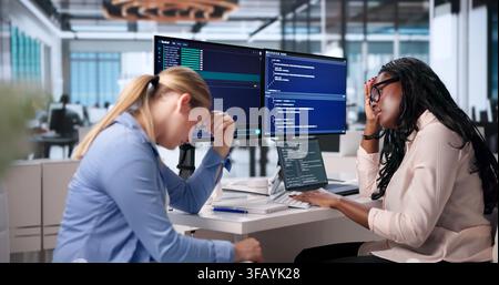 Tired Woman Coder Struggles Late At Night With Her Laptop. Stock Photo
