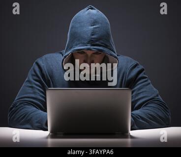 The computer hacker works in a dark room Stock Photo