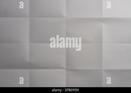 Folded white paper sheet texture with grid creases, top view. Full frame background of blank white paper sheet with geometric fold marks and realistic Stock Photo
