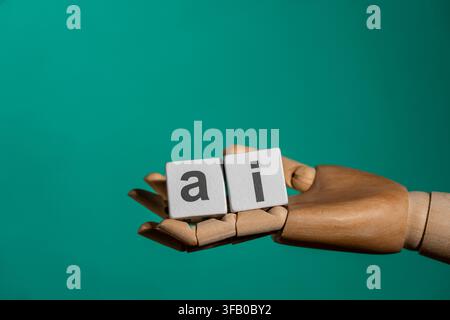 Wooden robot hand holding cubes with AI text abbreviation. Mannequin hand holding white blocks with lowercase letters spelling AI. Artificial intellig Stock Photo