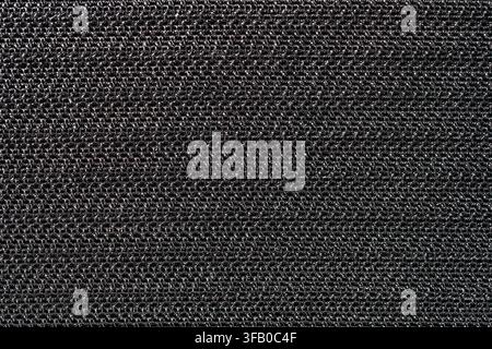 Black synthetic mesh fabric texture background. Full frame macro texture of dark black breathable nylon mesh fabric close up background for sportswear Stock Photo