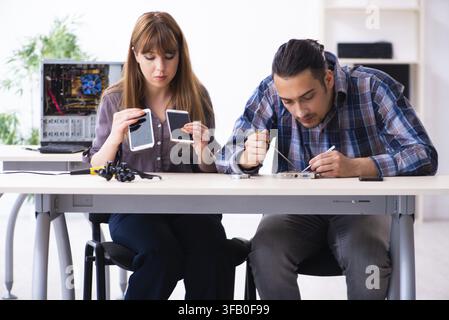 The two technicians who work in the computer warranty center Stock Photo