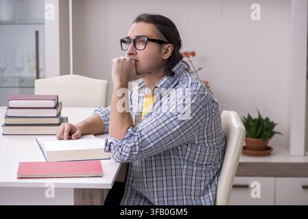 Male student preparing for exam at home Stock Photo