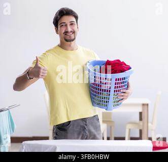 The handsome man doing laundry at home Stock Photo