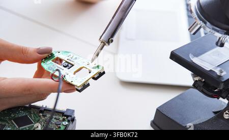 The engineer repairs a broken computer hard drive Stock Photo