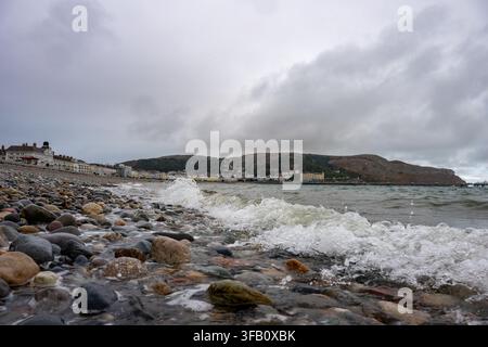 Waves crashing over the pebbles at Llandudno Beach Stock Photo