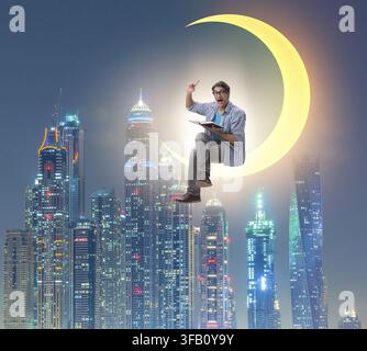 The student is reading a book on the crescent Stock Photo