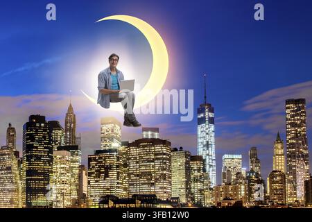 The student is working on a laptop on the crescent moon Stock Photo