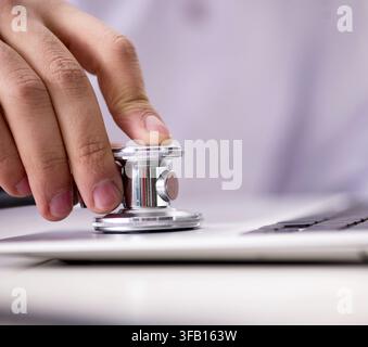The IT technician repairs a broken laptop notebook Stock Photo