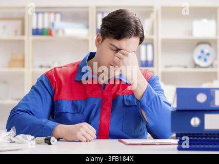 The worker in uniform is working on the project Stock Photo