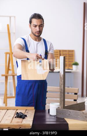Young male contractor working in workshop Stock Photo