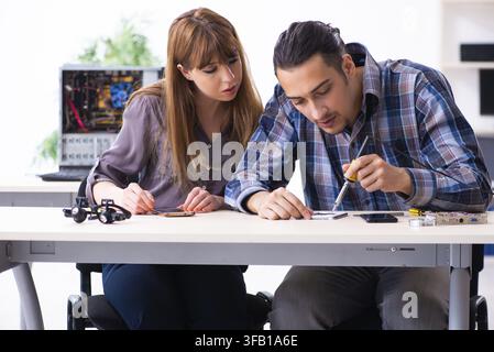 The two technicians who work in the computer warranty center Stock Photo