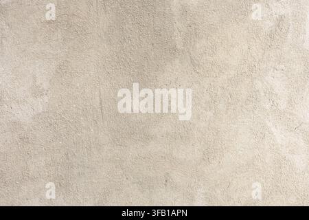 Beige plaster texture, close-up of light concrete wall with old rough surface, textured abstract background. Stock Photo