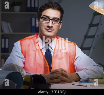 The building architect is working on drawings late at night Stock Photo