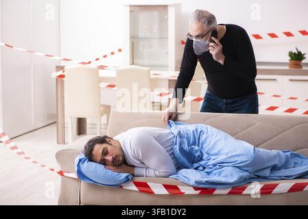 Father and son in the coronavirus concept at home Stock Photo