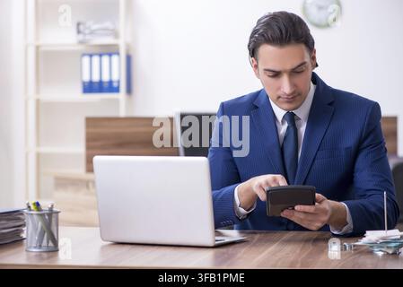 Young male businessman works in office Stock Photo