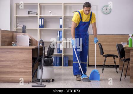 Male contractor cleaning office Stock Photo