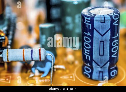 Electronic components resistor and capacitor on TV circuit board, macro close-up Stock Photo