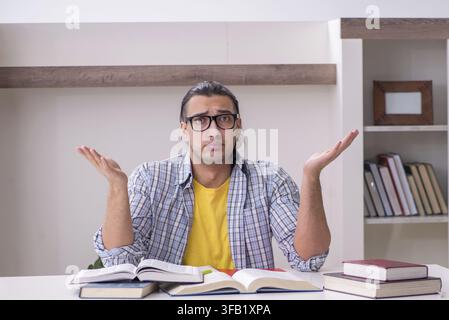 Male student preparing for exam at home Stock Photo