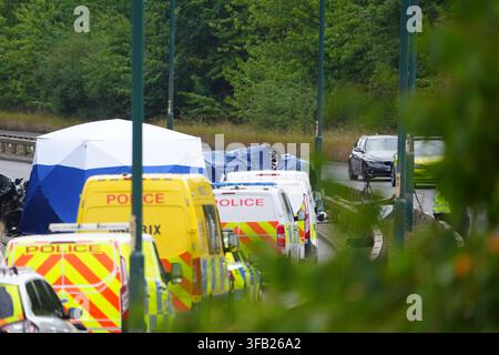 Police officers at the scene of a fatal crash involving a police car and a Volkswagen Passat on the A66 in South Bank, near Middlesbrough. An investigation has been launched into a crash which killed several people following a police pursuit in the early hours of Saturday morning, the police watchdog said. Picture date: Saturday August 22, 2026. Stock Photo
