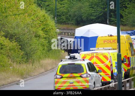 Police officers at the scene of a fatal crash involving a police car and a Volkswagen Passat on the A66 in South Bank, near Middlesbrough. An investigation has been launched into a crash which killed several people following a police pursuit in the early hours of Saturday morning, the police watchdog said. Picture date: Saturday August 22, 2026. Stock Photo
