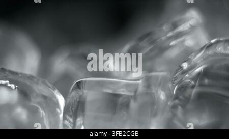 Ice cubes up close with a soft focus, creating an abstract background of cold, clear, frozen water Stock Photo