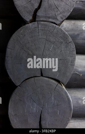 Vertical cross section of dark log timber wall joints Stock Photo