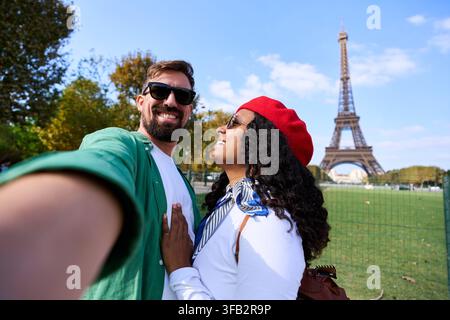Happy couple taking selfie with eiffel tower in paris Stock Photo