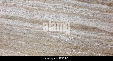 Travertine stone surface showcasing natural layered texture and warm beige brown tones Stock Photo