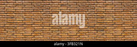 Old brown brick wall displaying a textured pattern for construction backgrounds Stock Photo