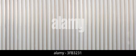 Corrugated metal wall panel forming a light texture and striped pattern Stock Photo