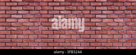 Red brick wall displaying a textured surface and repeating pattern Stock Photo