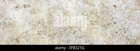Travertine stone surface displaying natural beige and brown texture Stock Photo