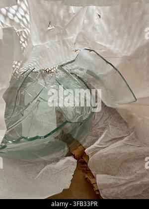 package delivered with glass bowl is broken and wrapped in paper for disposal. Stock Photo