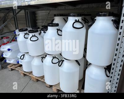 Plastic containers stacked in a store showing various sizes and shapes. Stock Photo